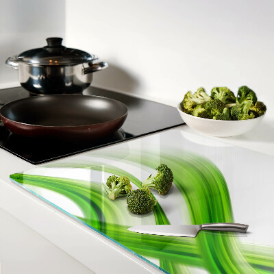 Glas-Schneidebrett mit grünem abstraktem Wellenmotiv