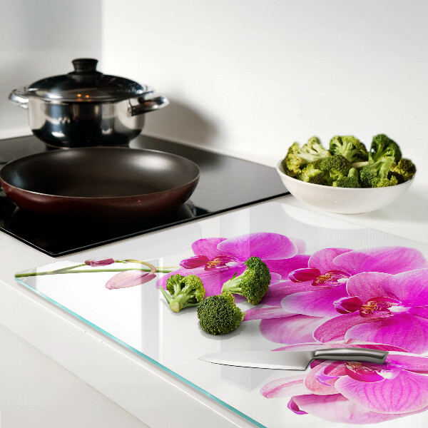Glas-Schneidebrett mit Orchideen in Rosatönen