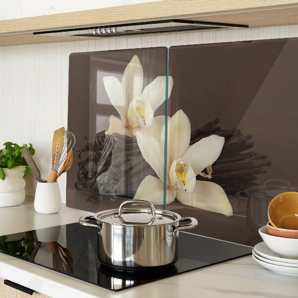 Glas-Schneidebrett mit Orchideen und Vanilleschoten als Motiv