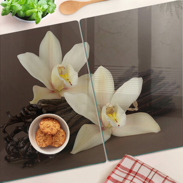 Glas-Schneidebrett mit Orchideen und Vanilleschoten als Motiv