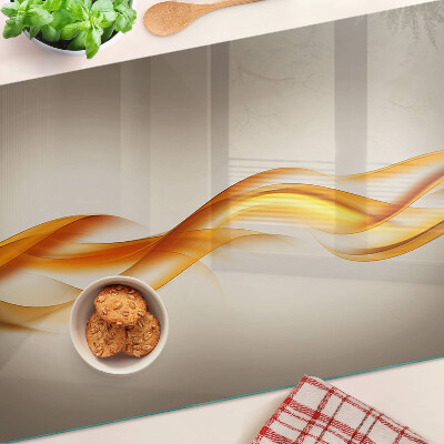 Schneidebrett Glas mit wellenförmigem Muster in Goldtönen