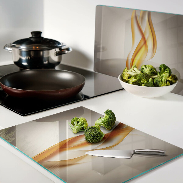 Schneidebrett Glas mit wellenförmigem Muster in Goldtönen