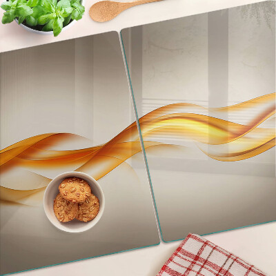 Schneidebrett Glas mit wellenförmigem Muster in Goldtönen