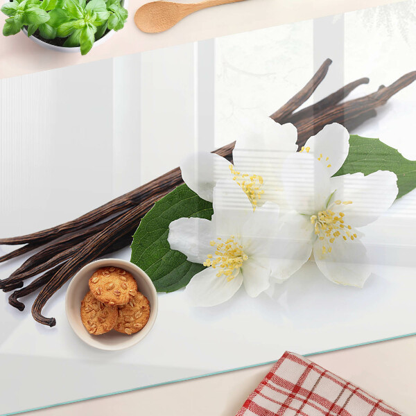 Schneidebrett mit Motiv aus Vanilleblüten und -schoten