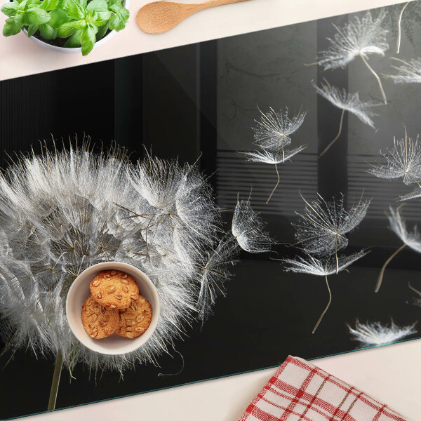 Schneidebrett Glas mit Löwenzahnmotiv auf schwarzem Hintergrund