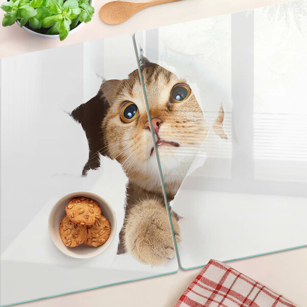 Schneidebrett mit Motiv einer Katze, die durch ein Loch in der Wand schaut
