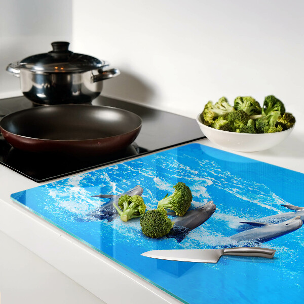 Schneidebrett glas Delfine, die über Wellen springen