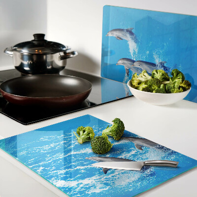 Schneidebrett glas Delfine, die über Wellen springen