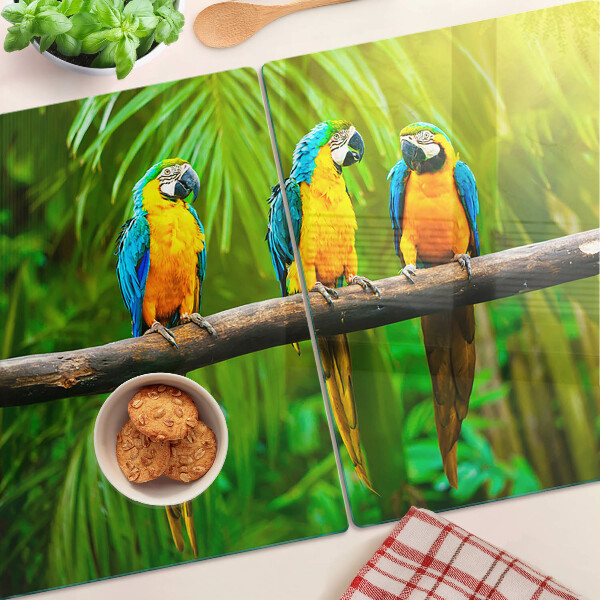 Schneidebrett mit Motiv Papageien auf einem Ast in tropischer Umgebung