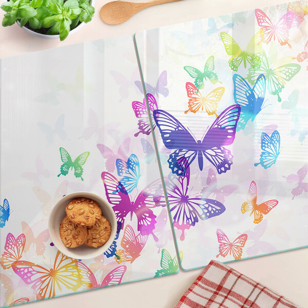 Glas-Schneidebrett mit einem Motiv aus bunten Schmetterlingen, die davonfliegen