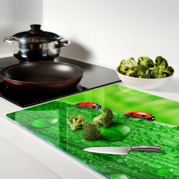 Schneidebrett mit einem Marienkäfer auf grünem Hintergrund