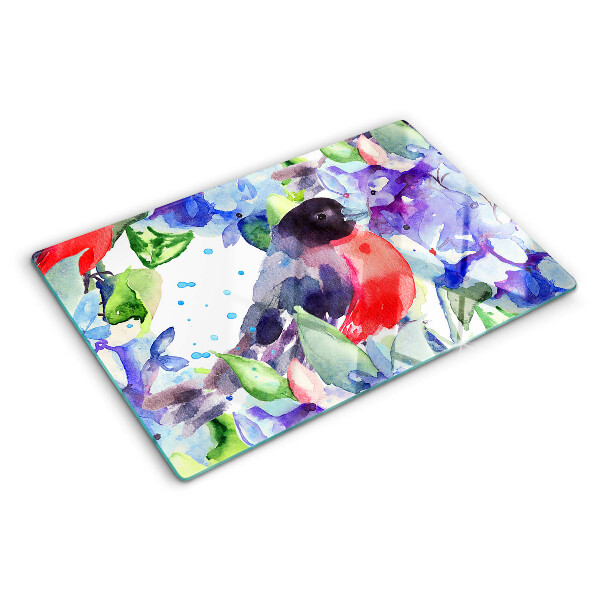 Glas-Schneidebrett mit einem Motiv eines Vogels vor einem Blumenhintergrund