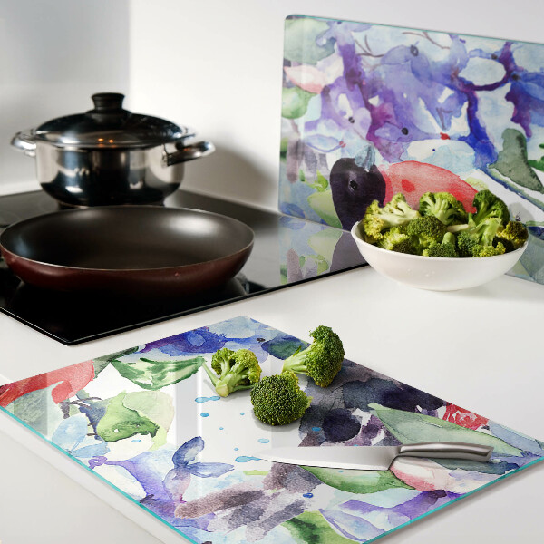 Glas-Schneidebrett mit einem Motiv eines Vogels vor einem Blumenhintergrund