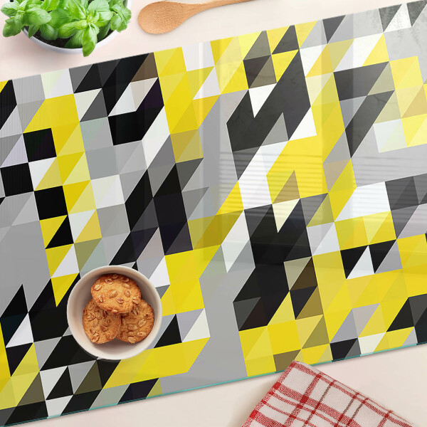 Glas-Schneidebrett mit geometrischem Muster in Gelb- und Schwarztönen
