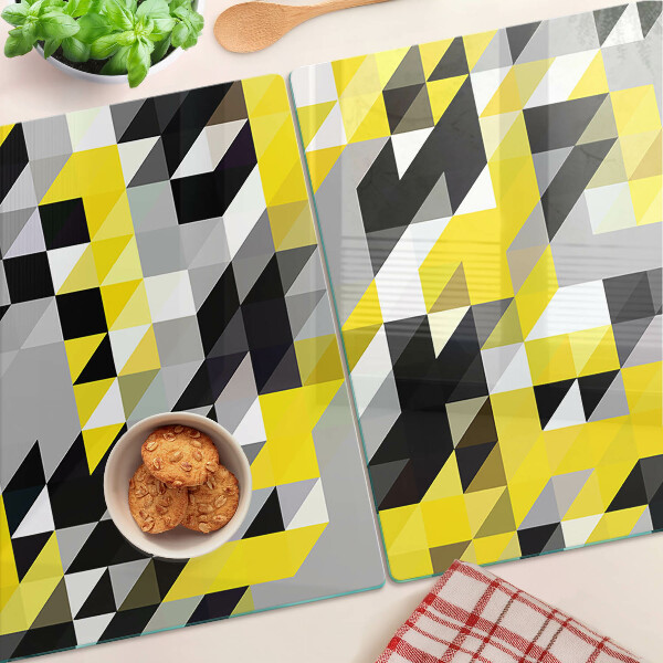 Glas-Schneidebrett mit geometrischem Muster in Gelb- und Schwarztönen