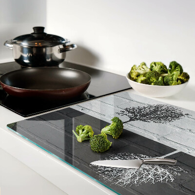 Schneidebrett Glas mit Motiv eines Baums vor einem Backsteinhintergrund