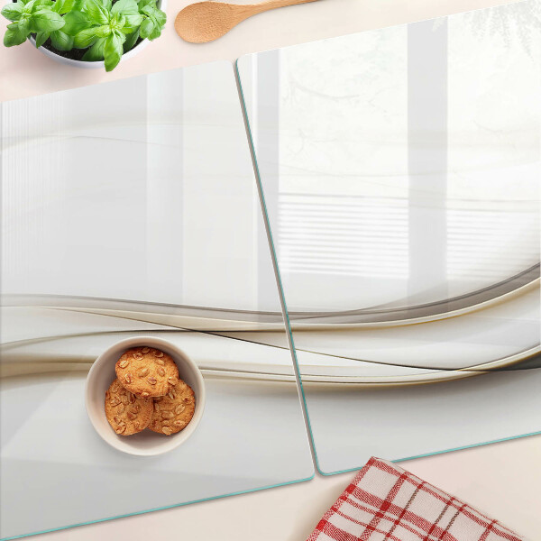 Glas-Schneidebrett mit abstrakten Wellen in Beigetönen