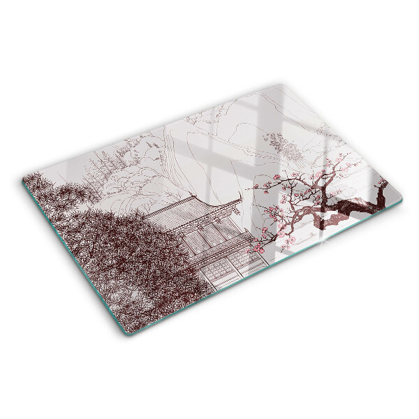 Glas-Schneidebrett mit einer Berglandschaft und blühenden Bäumen