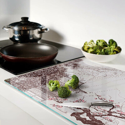 Glas-Schneidebrett mit einer Berglandschaft und blühenden Bäumen