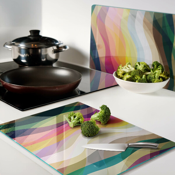 Glas-Schneidebrett mit abstrakten Farbwellen als Motiv