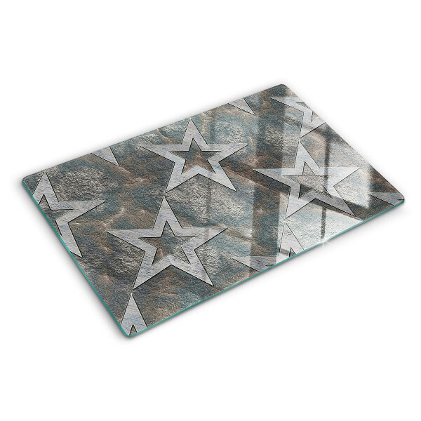 Glas-Schneidebrett mit Sternmotiv auf strukturiertem Hintergrund