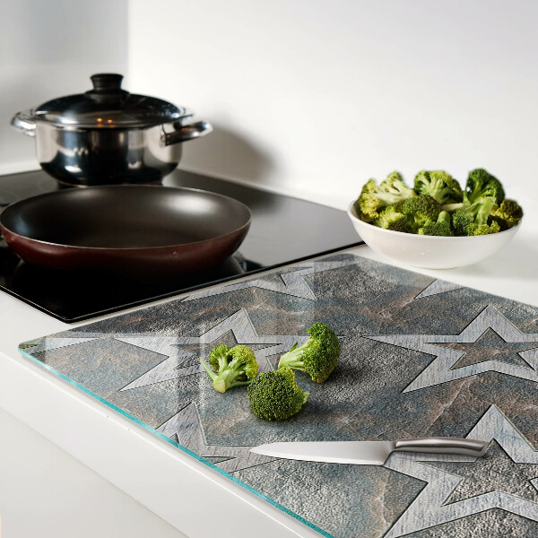 Glas-Schneidebrett mit Sternmotiv auf strukturiertem Hintergrund