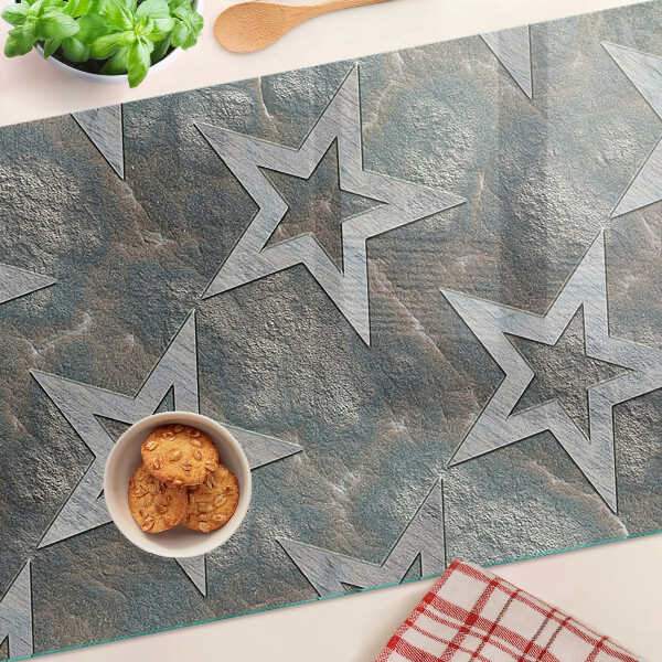 Glas-Schneidebrett mit Sternmotiv auf strukturiertem Hintergrund