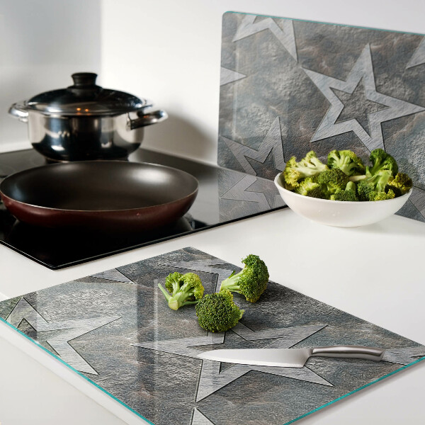 Glas-Schneidebrett mit Sternmotiv auf strukturiertem Hintergrund