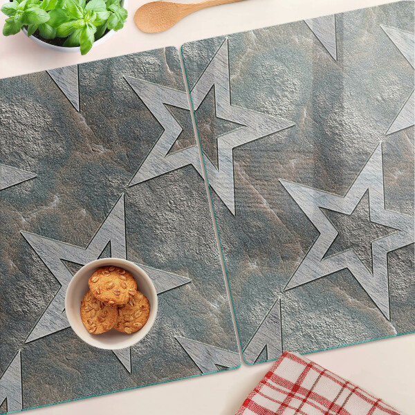 Glas-Schneidebrett mit Sternmotiv auf strukturiertem Hintergrund
