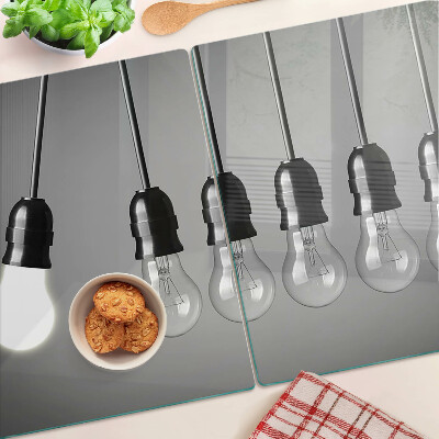 Schneidebrett mit Motiv von Glühbirnen an Kabeln