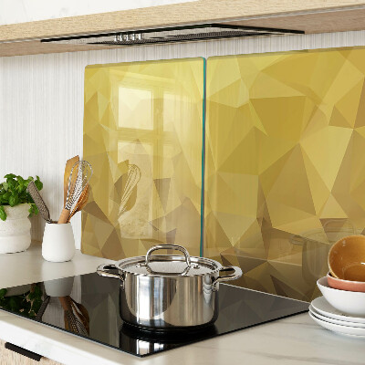 Glas-Schneidebrett mit geometrischem Muster in Goldtönen