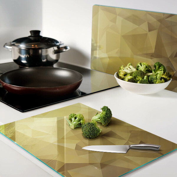 Glas-Schneidebrett mit geometrischem Muster in Goldtönen