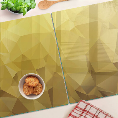 Glas-Schneidebrett mit geometrischem Muster in Goldtönen