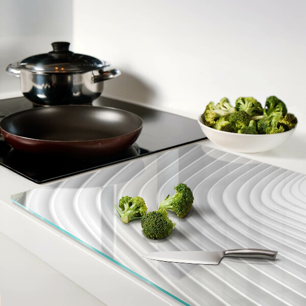 Glas-Schneidebrett mit Wellen- und Linienmotiv in Grautönen