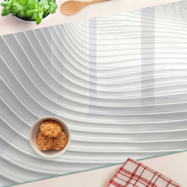 Glas-Schneidebrett mit Wellen- und Linienmotiv in Grautönen