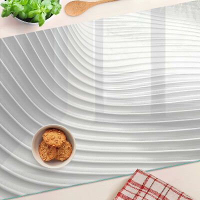 Glas-Schneidebrett mit Wellen- und Linienmotiv in Grautönen