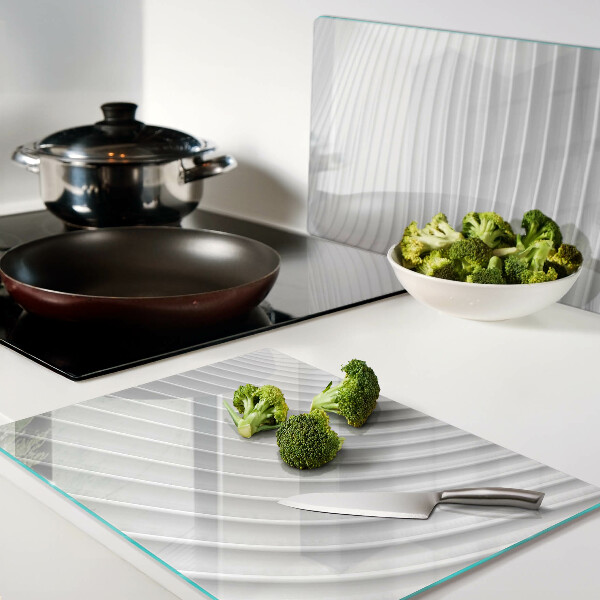 Glas-Schneidebrett mit Wellen- und Linienmotiv in Grautönen