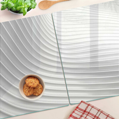 Glas-Schneidebrett mit Wellen- und Linienmotiv in Grautönen