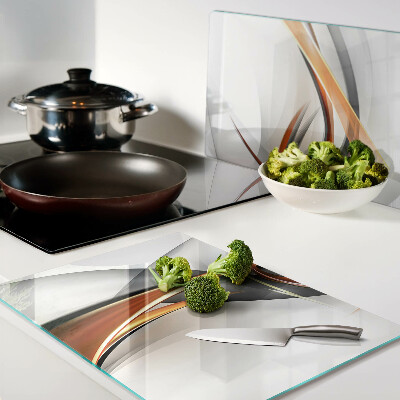 Schneidebrett Glas mit abstraktem Wellenmuster in Goldtönen