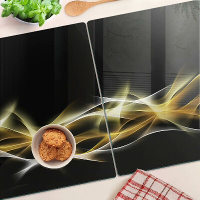 Glas-Schneidebrett mit einem goldfarbenen Lichtwellendekor