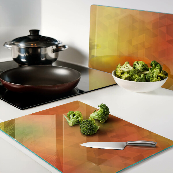 Glas-Schneidebrett mit geometrischem Muster in Orangetönen