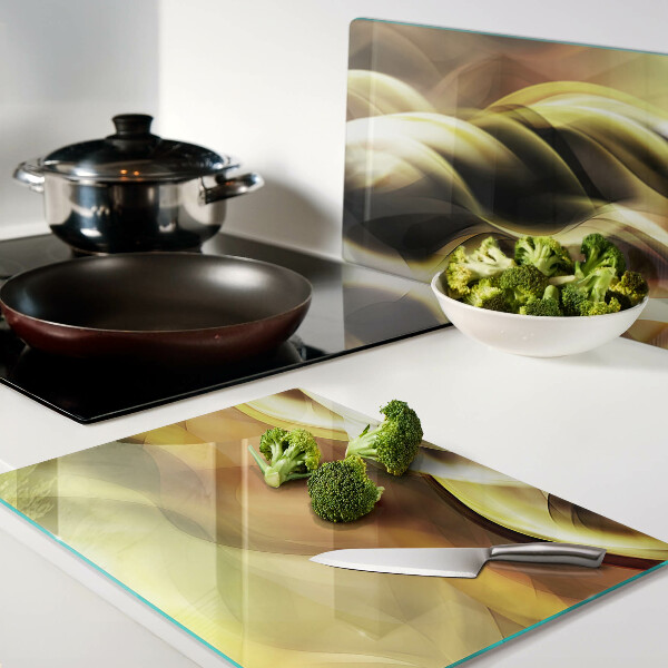 Schneidebrett Glas mit abstrakten Wellen in Goldtönen