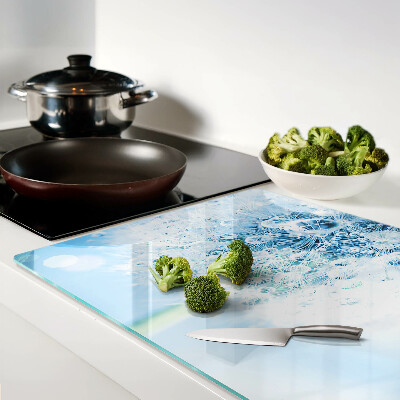 Glas-Schneidebrett mit einem Motiv aus Löwenzahnblüten und Wassertropfen