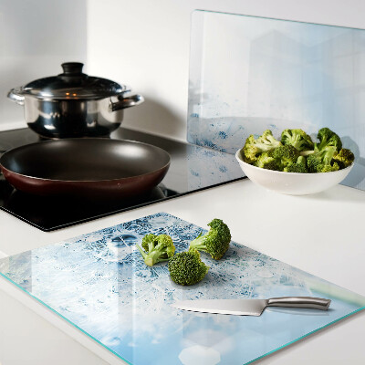 Glas schneidebrett Löwenzahnblüte mit Wassertropfen