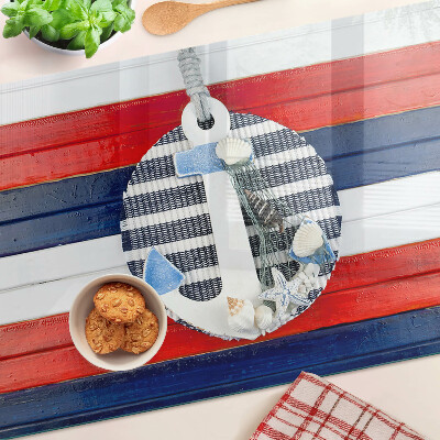 Glas Schneidebrett mit Anker-Motiv vor gestreiftem Hintergrund