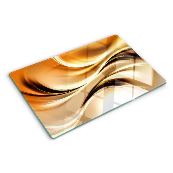 Glas-Schneidebrett mit abstraktem Wellenmotiv in Goldtönen