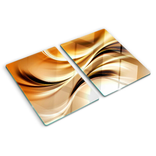 Glas-Schneidebrett mit abstraktem Wellenmotiv in Goldtönen