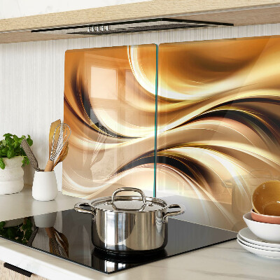 Glas-Schneidebrett mit abstraktem Wellenmotiv in Goldtönen