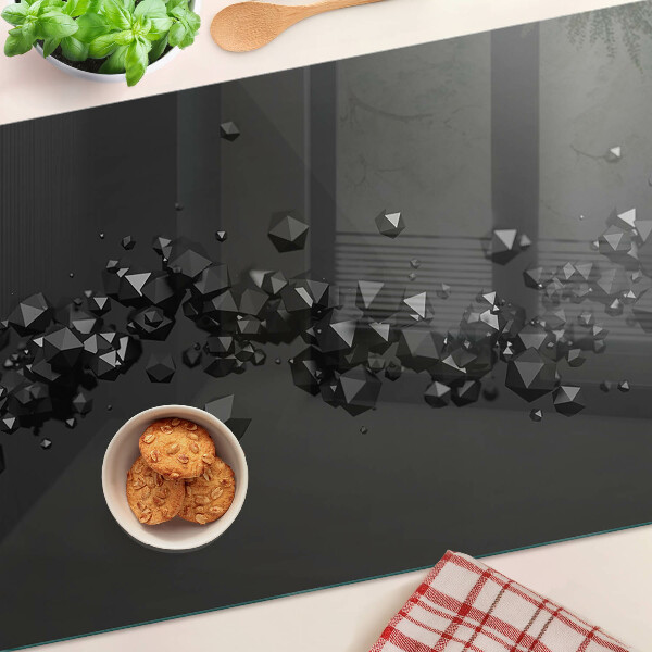 Schneidebrett glas Schwarze Kristalle im Hintergrund