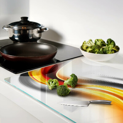 Glas-Schneidebrett mit Wellenmotiv in Orange und Schwarz